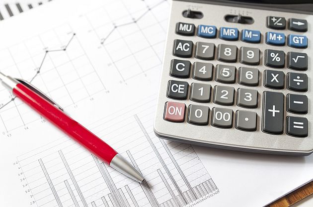 Calculator and charts symbolizing alternative performance measures.