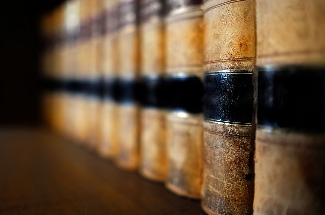 Old leather law books or lawbooks stacked on shelf