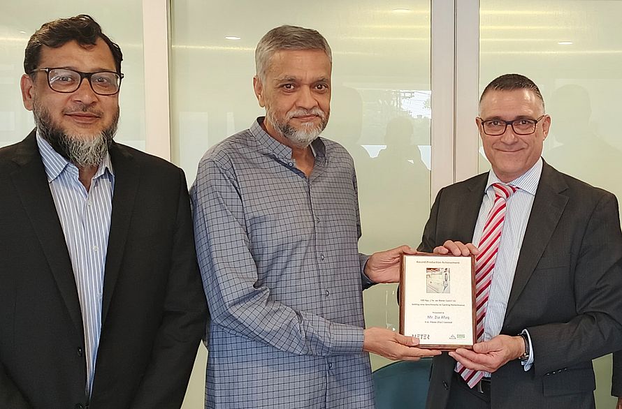 H.A. Fibres and Rieter representatives mark a production achievement.