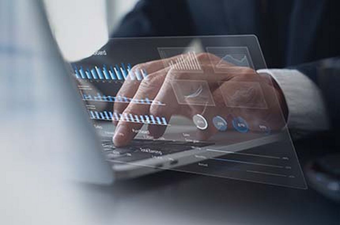 Symbol: Business person studying a financial report on a laptop computer