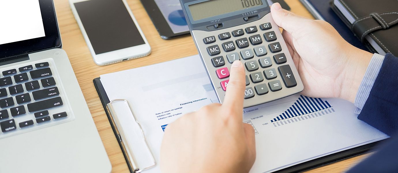 Man typing on a calculator
