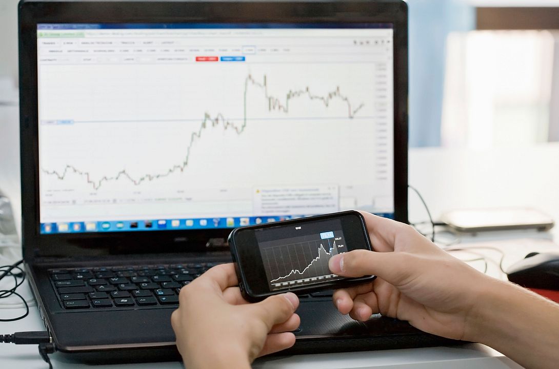 Stock chart on a mobile phone and laptop