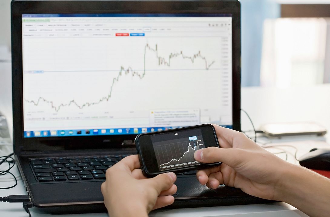 Stock chart on a mobile phone and laptop