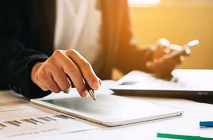 Symbol: Business person analyzing financial statements