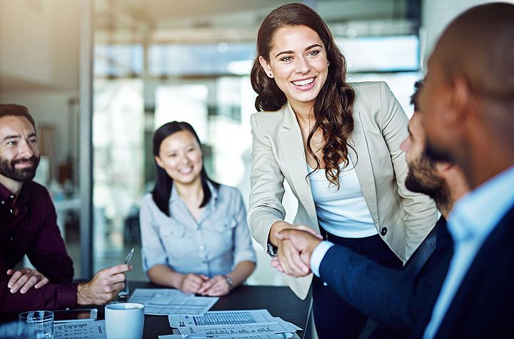 Employee welcoming a customer in a meeting