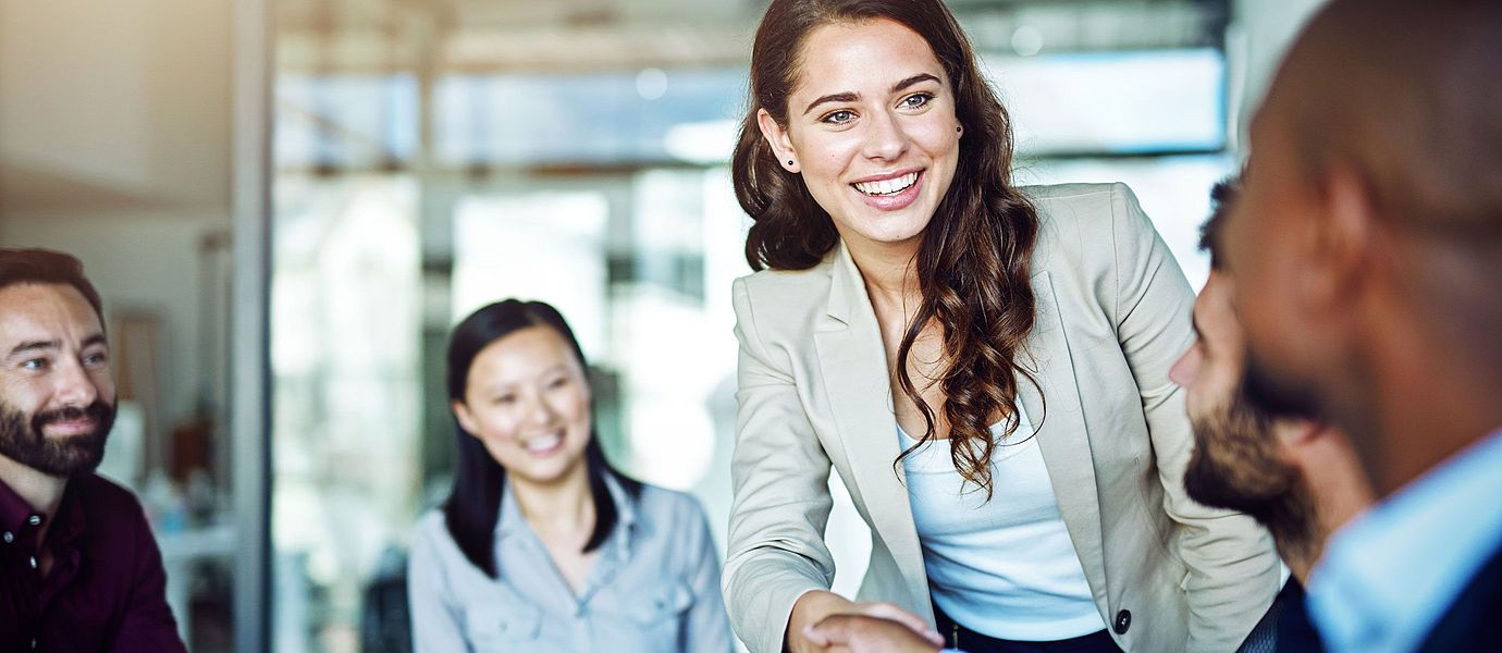 Employee welcoming a customer in a meeting